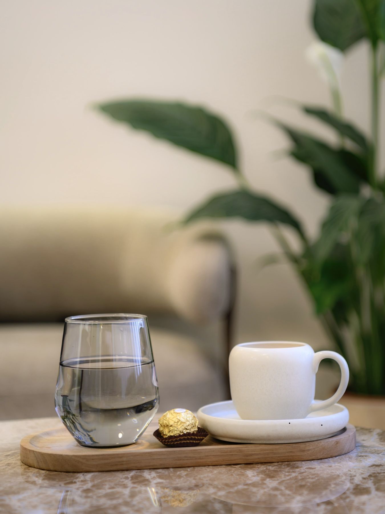 Glas Wasser und Kaffeetasse auf Holztablett